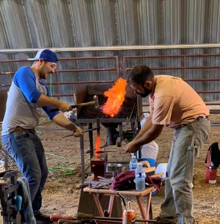 Master farrier shaping a horseshoe at the anvil